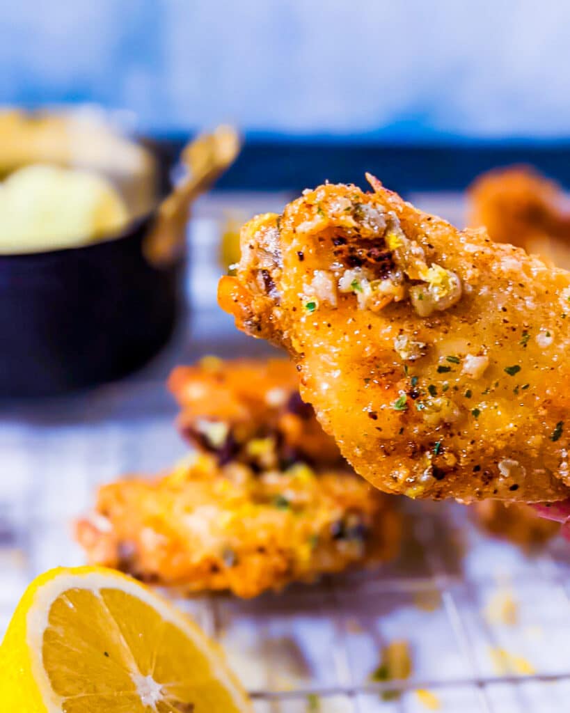 Close up picture of a flat wing with garlic and lemon butter drizzled.