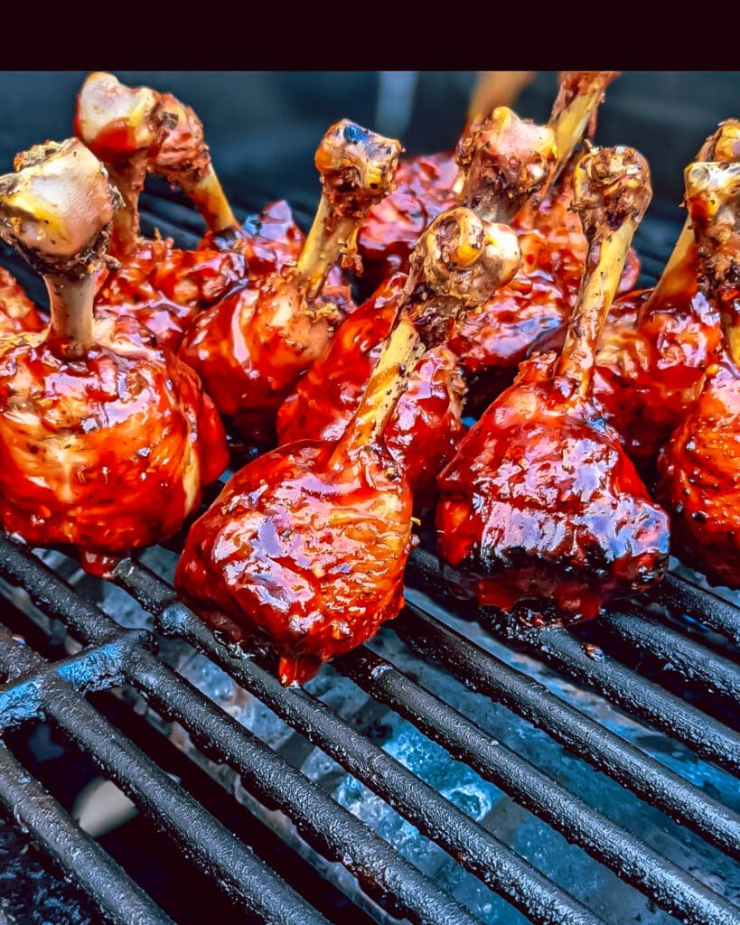 Lollipop drumsticks on the grill with BBQ sauce