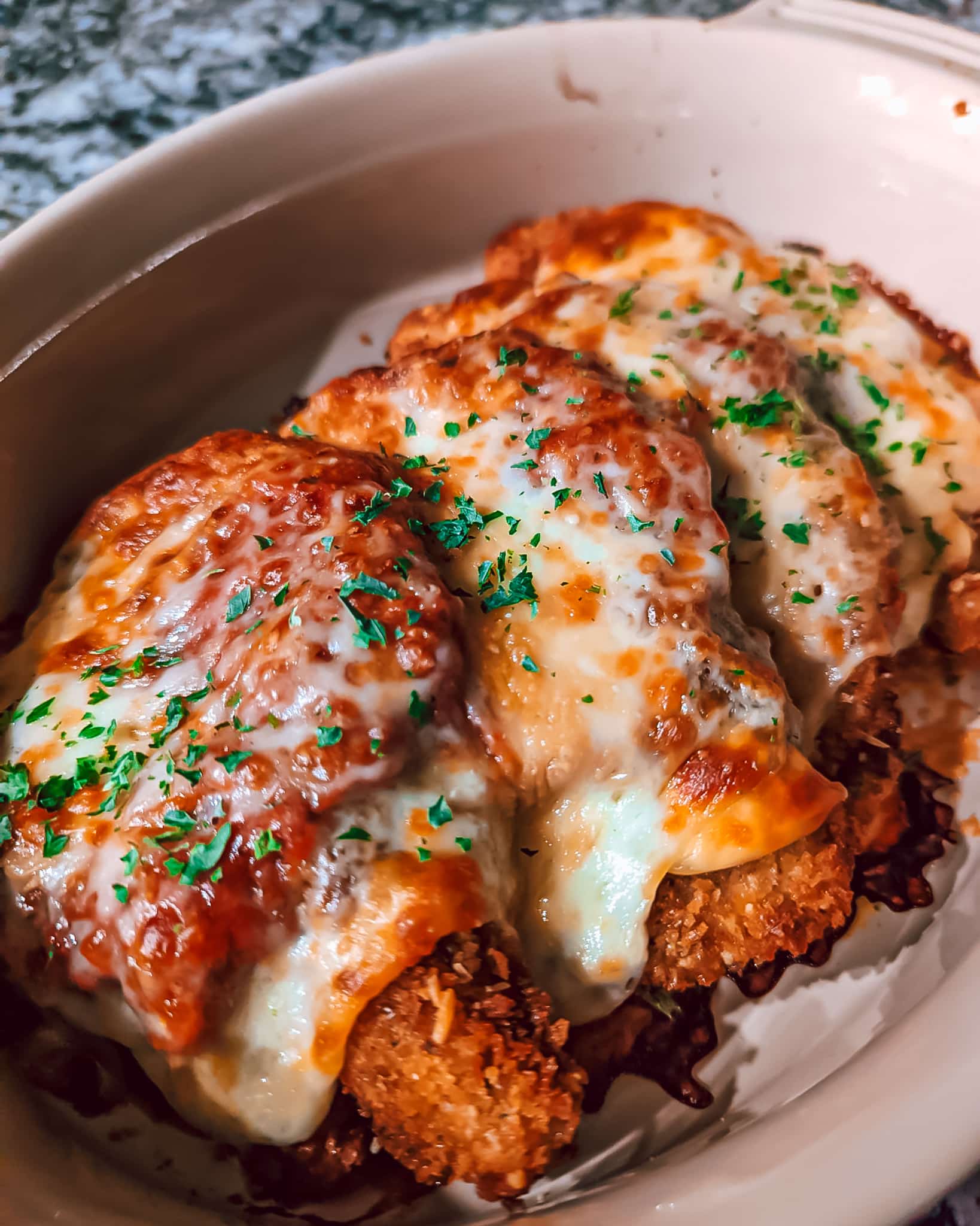 Layered chicken parmesan with cheese browned on top