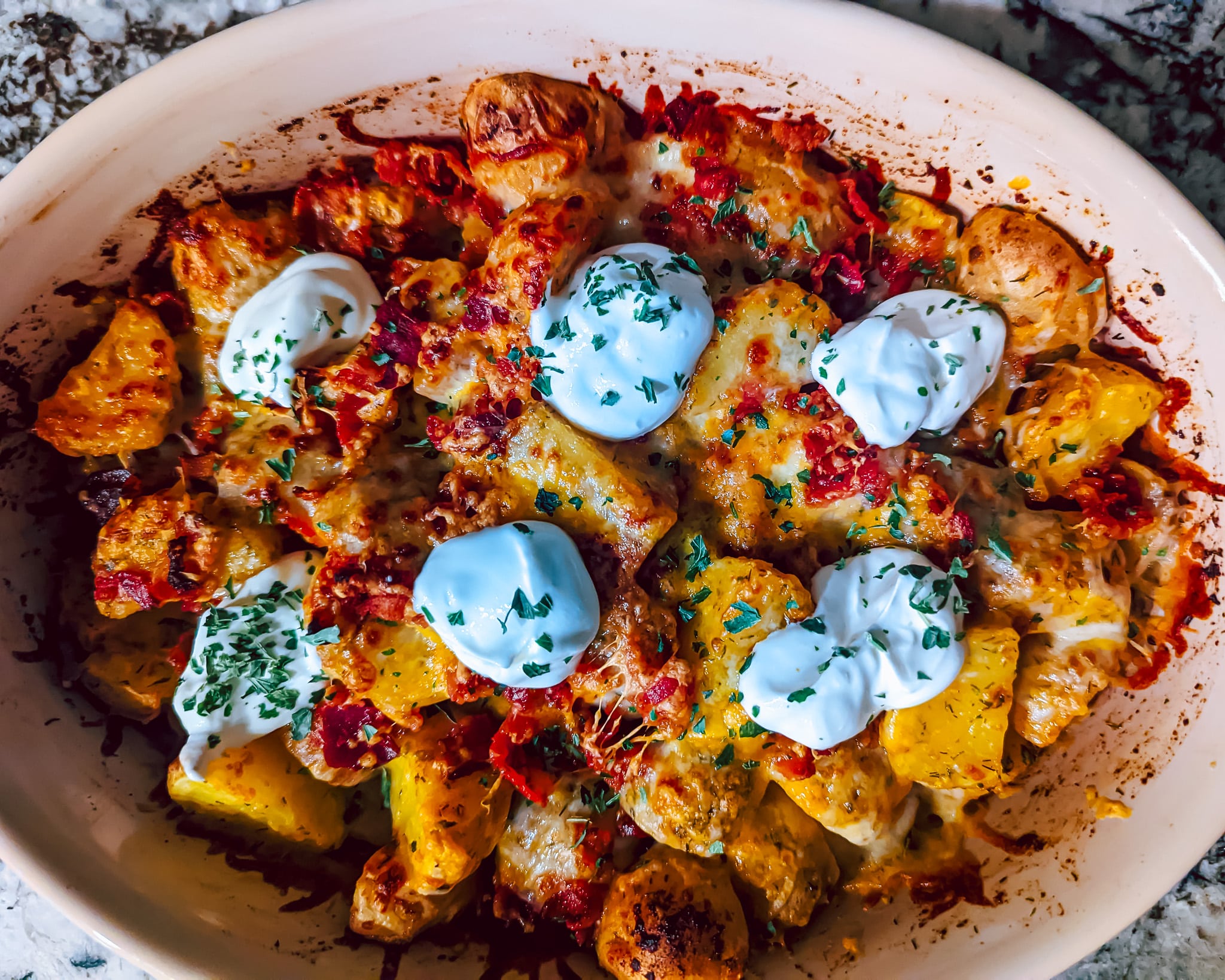 Over view of loaded ranch potatoes. Full of cheese and spices.